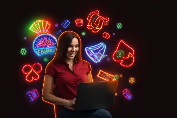 A woman smiling while playing online games on her laptop, surrounded by neon casino elements, showcasing WA777’s diverse game collection.