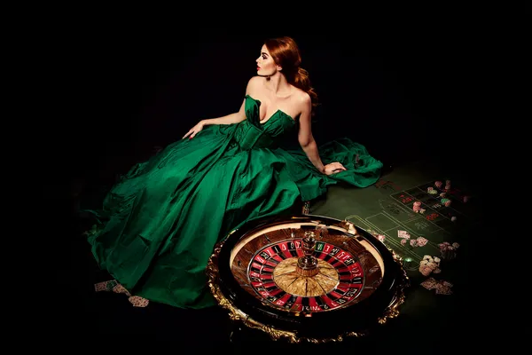 A woman in a luxurious green gown next to an ornate roulette wheel, capturing the upscale casino mood of WA777.