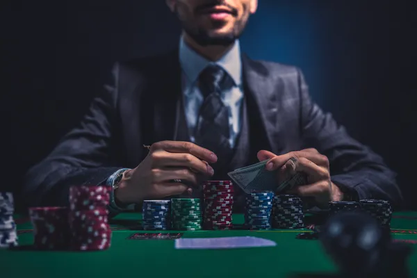 A confident dealer surrounded by casino chips inviting players to access their WA777 account, reflecting quick and easy login options.
